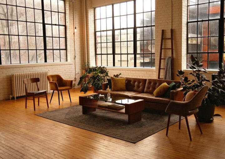 view of a loft style living room with a brown leather sofa